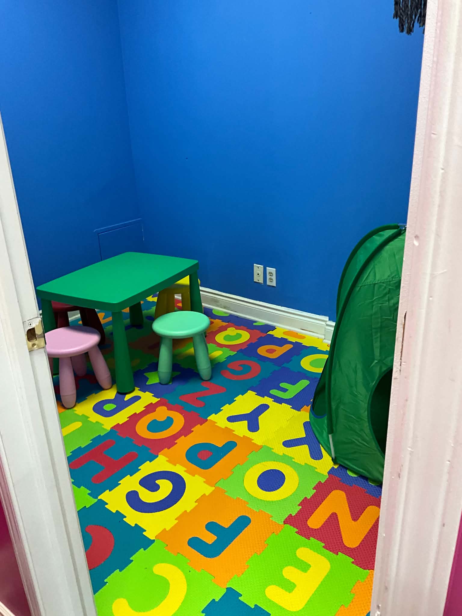 On-site kids playroom with foam mats and child seating